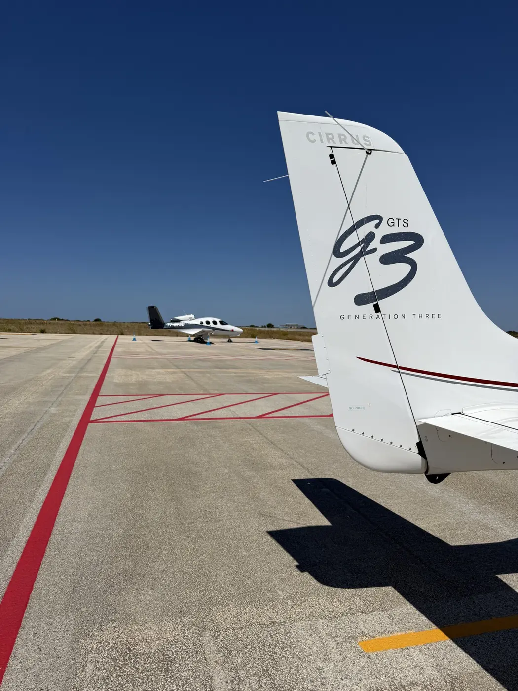 Cindy parked near a Cirrus Vision Jet